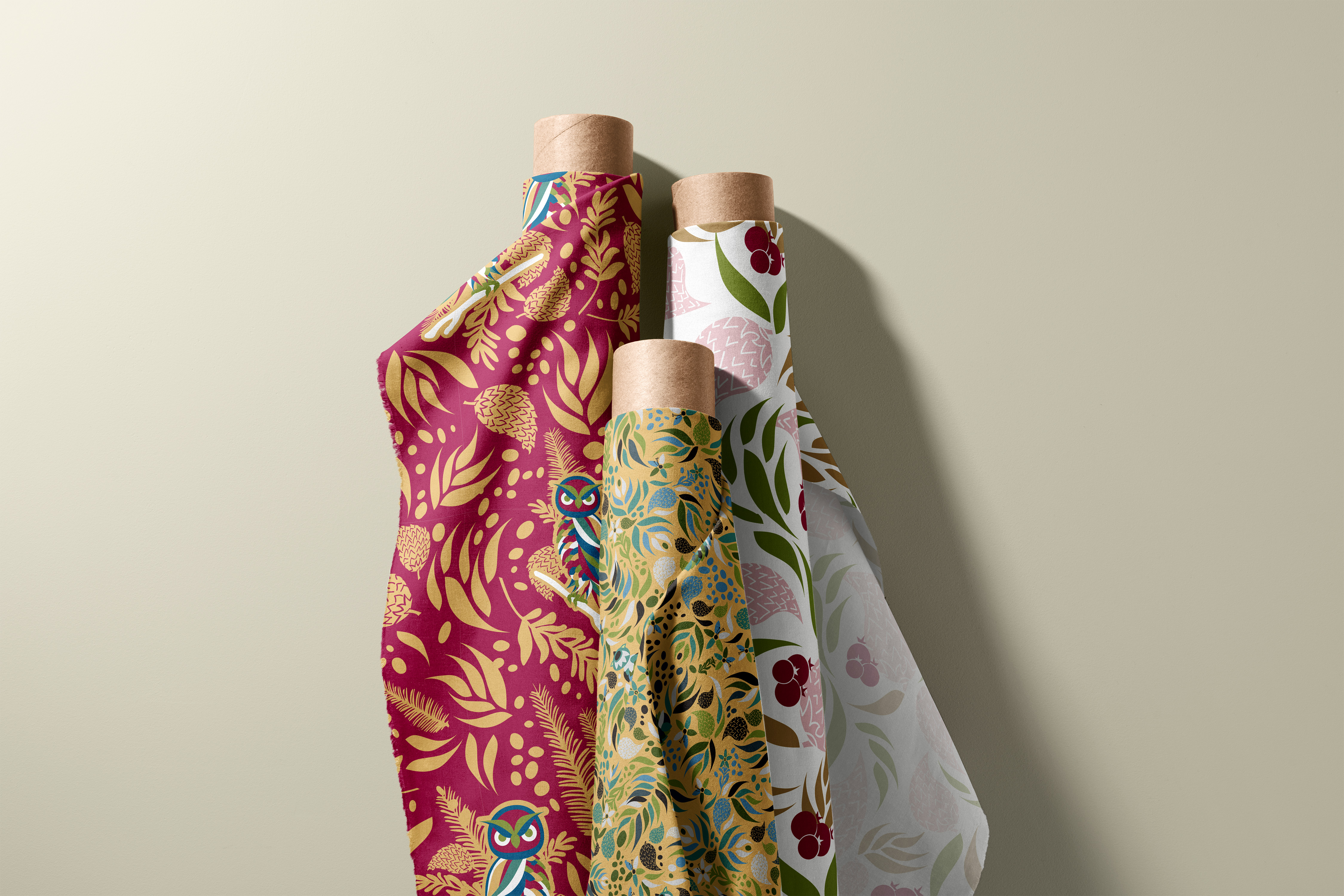 Three Hidden Owls coordinate prints draped over fabric bolt cores